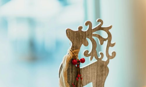 brown wooden carved reindeer decoration on table